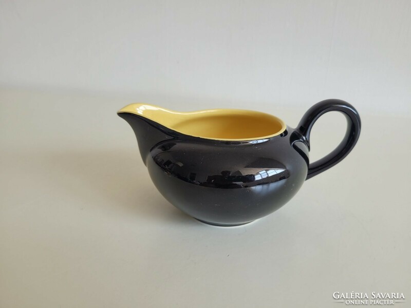 Glazed ceramic pouring black yellow small jug