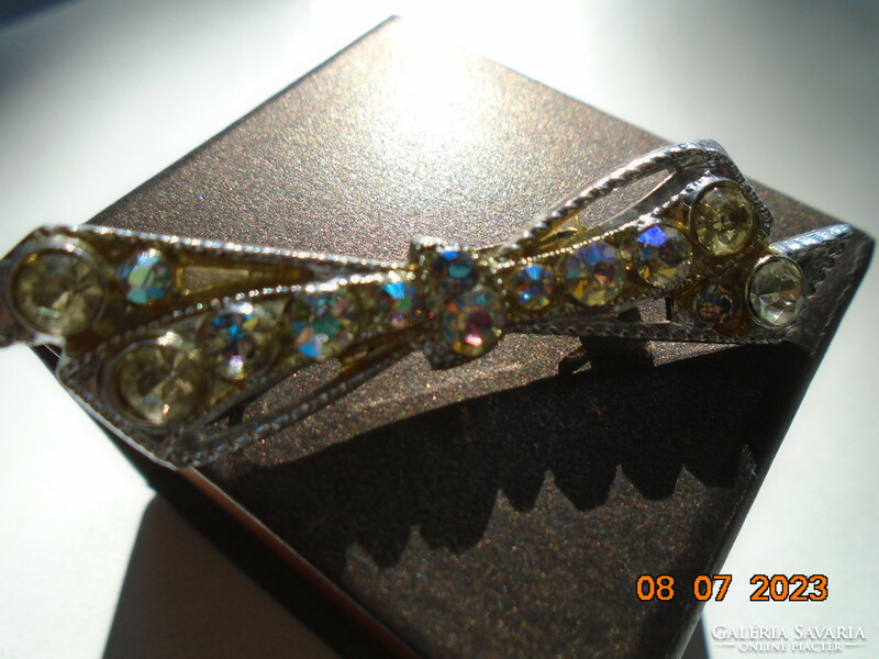 Silver-plated filigree bow brooch with polished iridescent stones