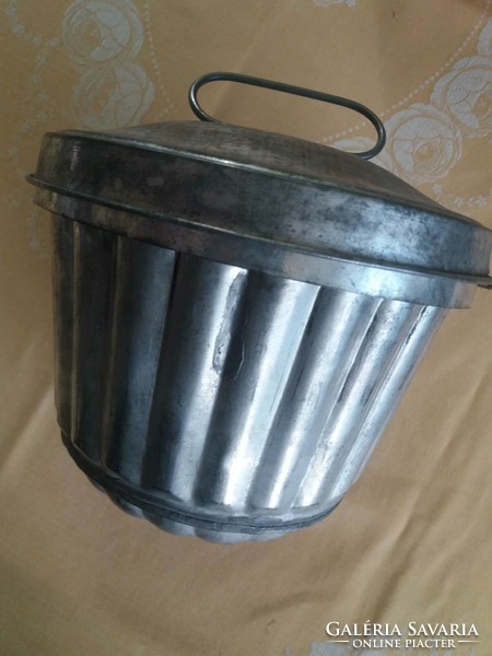Old metal pudding cooker with a lid
