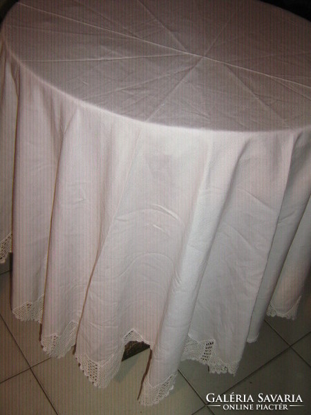 Beautiful, elegant, hand-crocheted white lace-edged round (many-angled) tablecloth