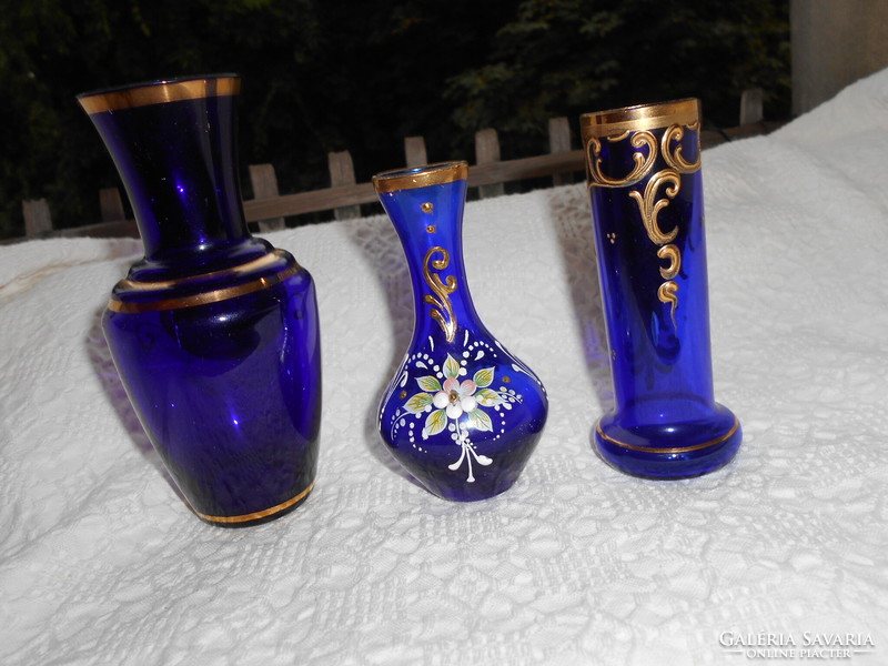 3 Bohemian plastic porcelain blue glass vases with flowers together.
