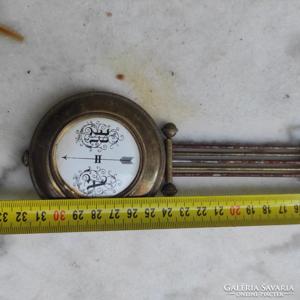 Antique wall clock pendulum made of copper enamel center.