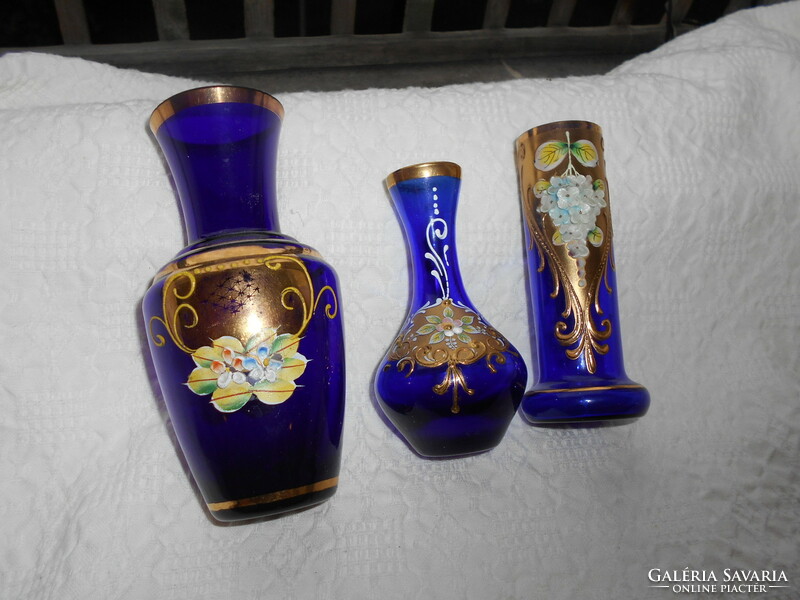 3 Bohemian plastic porcelain blue glass vases with flowers together.