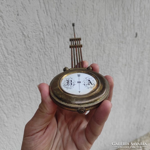 Antique wall clock pendulum made of copper enamel center.