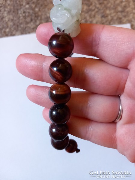 A beautiful bracelet decorated with a large tiger's eye and a carved jade dragon