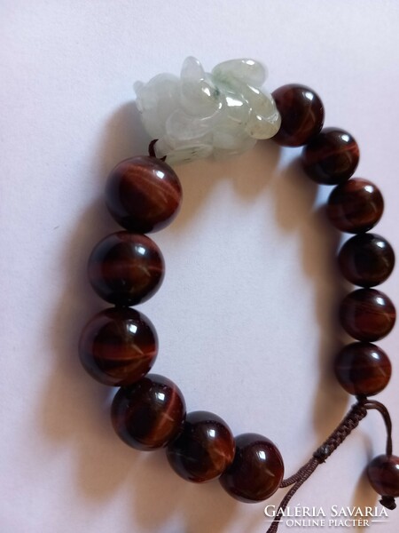 A beautiful bracelet decorated with a large tiger's eye and a carved jade dragon