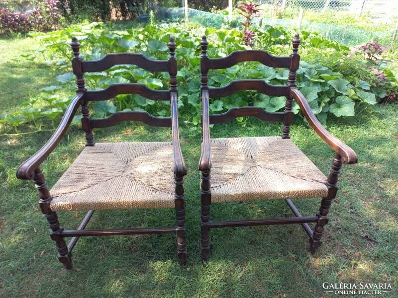 2 wooden chairs with armrests