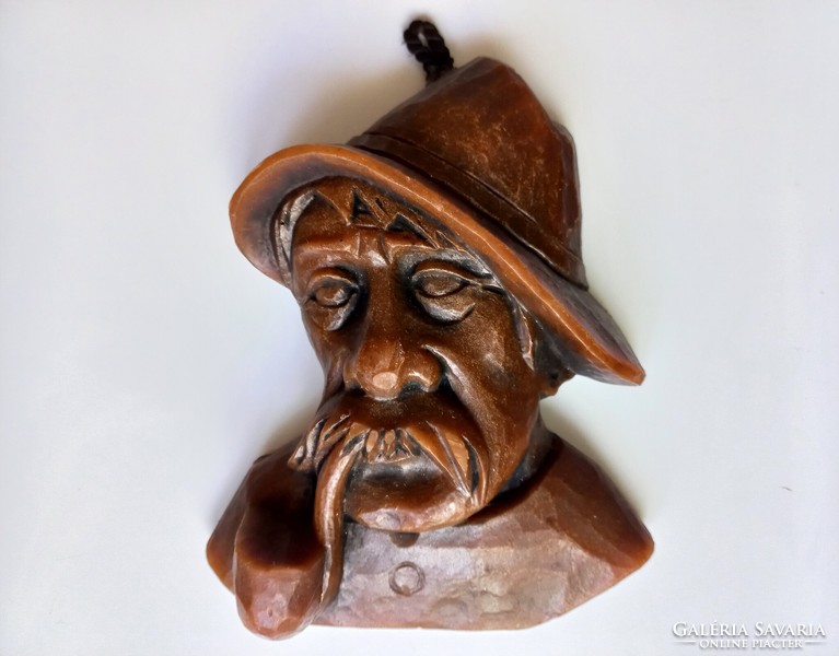 Wax figure of a man in a hat with a pipe