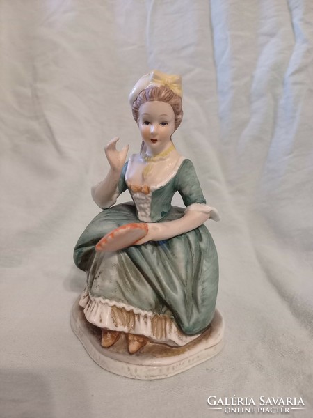 Seated woman in baroque green dress ceramics
