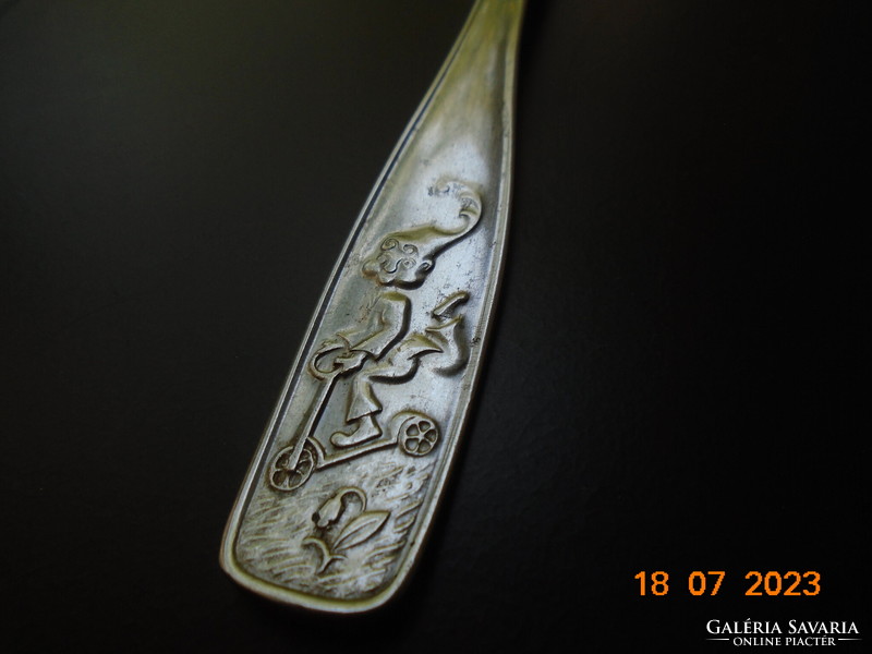 Stainless steel children's fork marked with a convex scooter clown on the handle