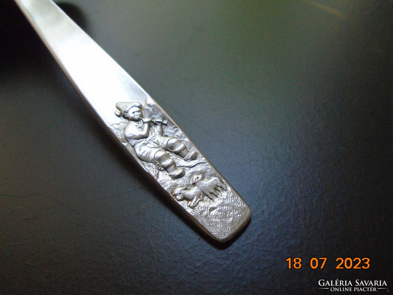 Embossed flute-playing boy with sheep on his handle, stainless steel baby food portioning shovel, oxydex Germany mark