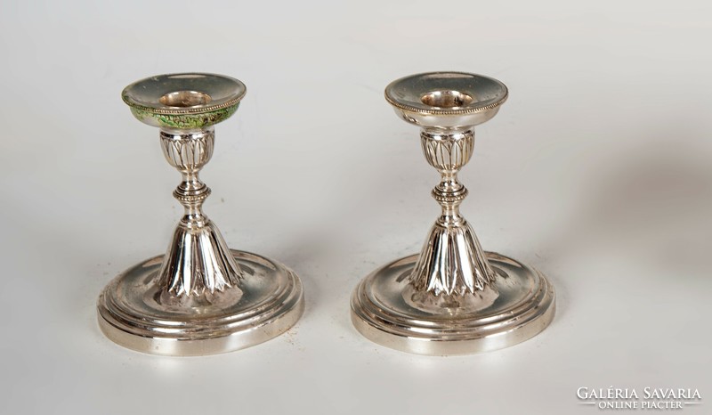 Pair of silver candlesticks with stylized leaf decor