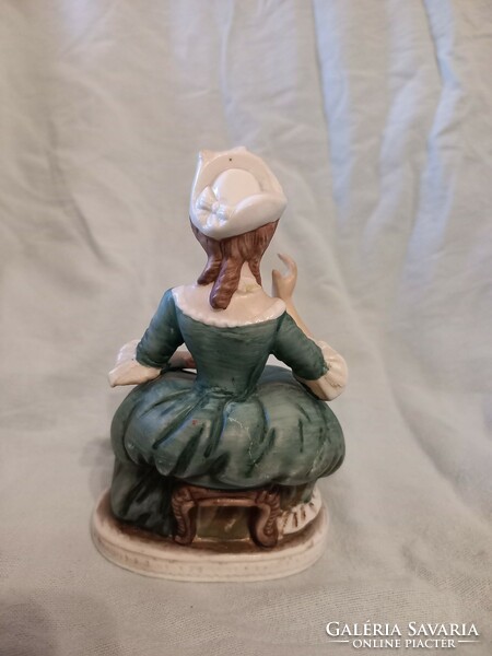 Seated woman in baroque green dress ceramics