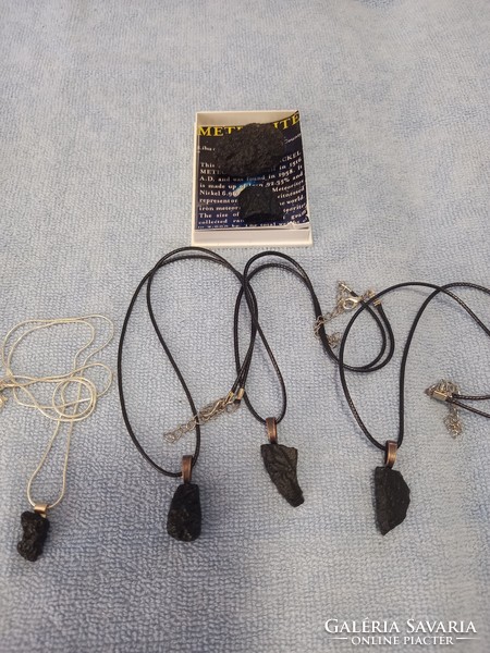 Raw tektite meteorite pieces on a leather chain