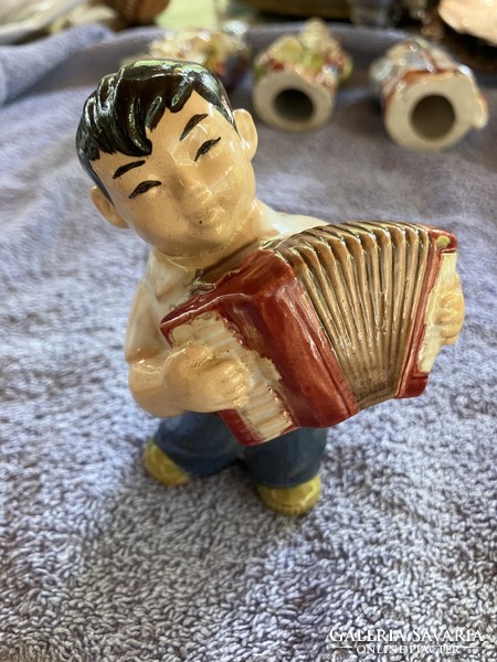 Porcelain boy figure with a Chinese accordion