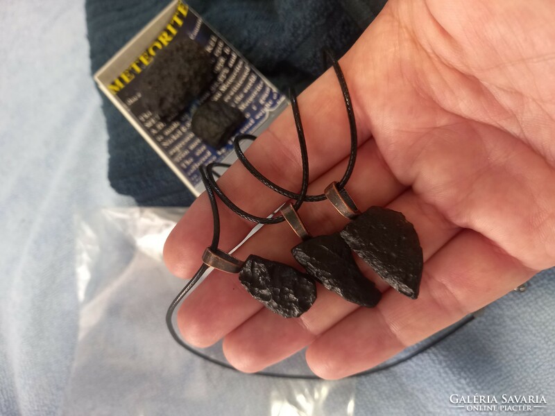 Raw tektite meteorite pieces on a leather chain