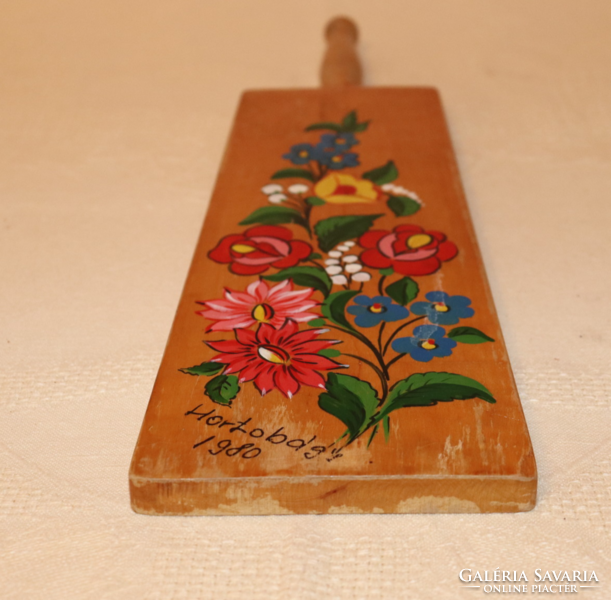 Wooden wall decoration with painted folk motifs
