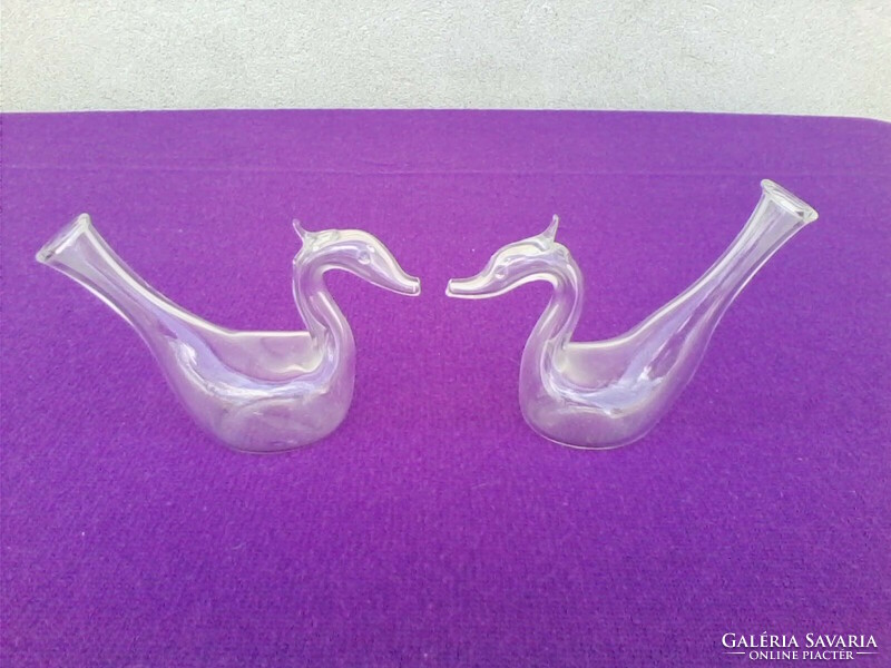 Glass swans in pairs