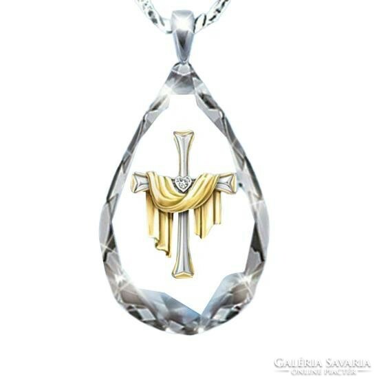 Polished drop-shaped crystal with a beautiful cross on it.