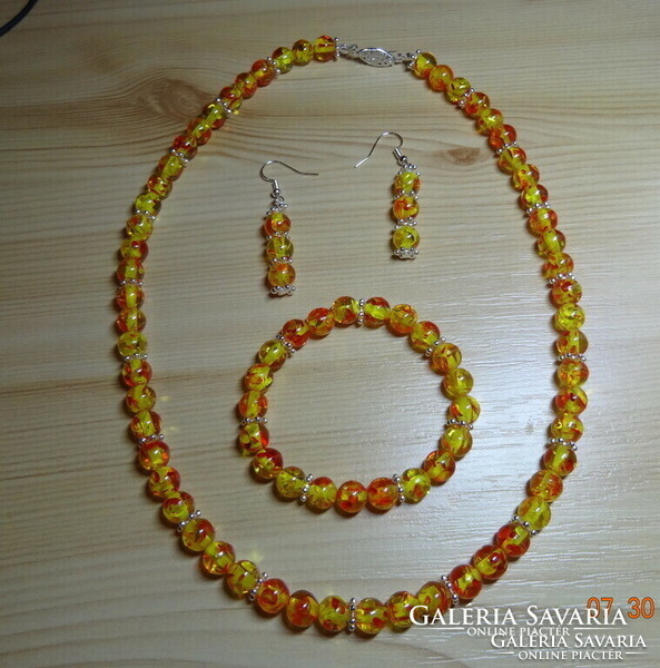 A jewelry set made of imitation amber pearls is eternal elegance.