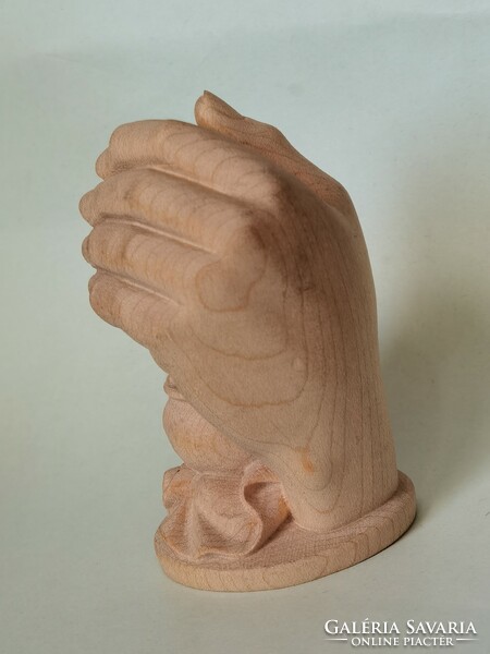 Carved wooden statue: a protective hand with a small child