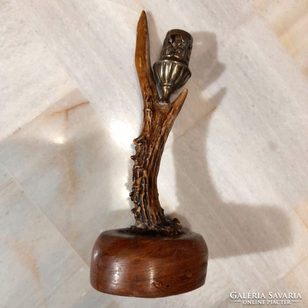 Antique horn copper candle holder on a wooden base