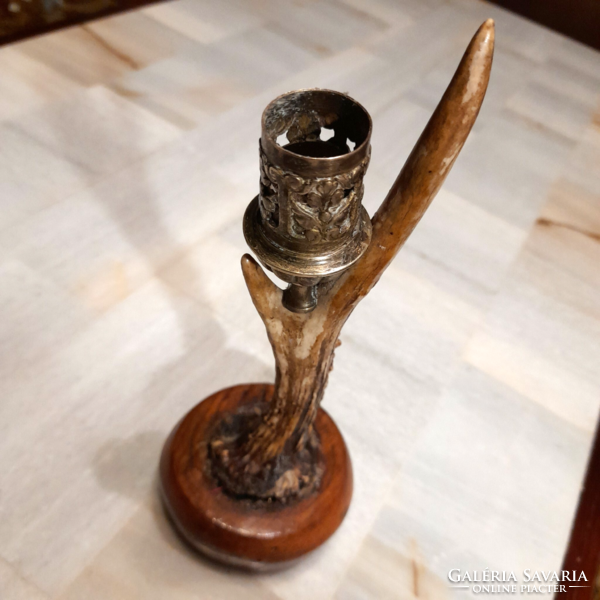 Antique horn copper candle holder on a wooden base