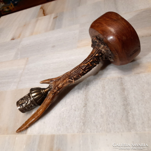 Antique horn copper candle holder on a wooden base