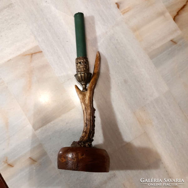 Antique horn copper candle holder on a wooden base
