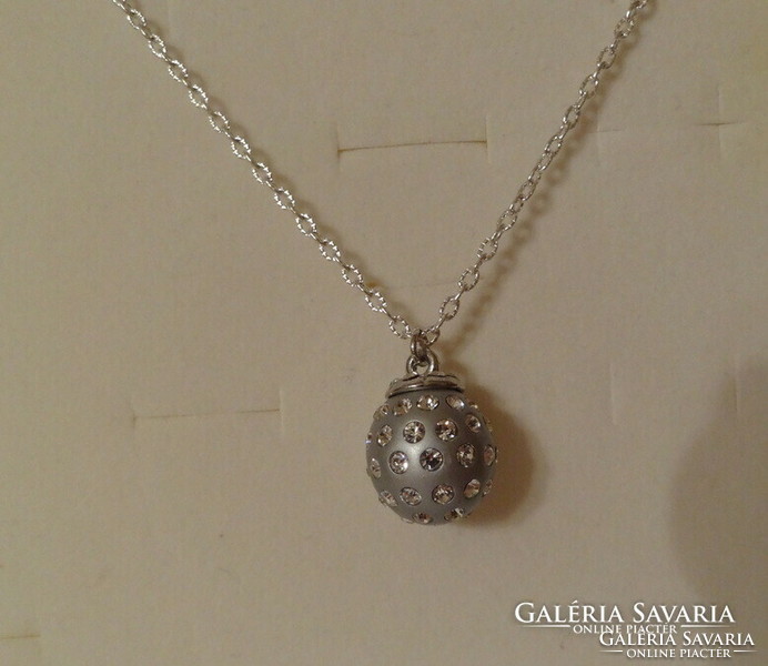 Silver-colored spherical pendant richly studded with zirconia stones, very showy.