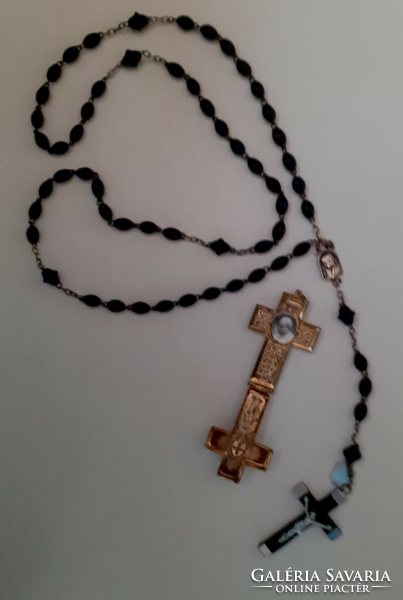 A rosary prayer chain made of old rosewood beads with a crucifix combined with a reliquary holder
