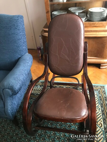Rocking chair with leather upholstery. In mint condition. 90 cm high.