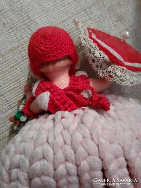 Old baby in a nice knitted crocheted dress holding an umbrella and a small crocheted bag