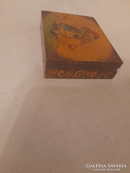 Carved and painted small box with the motif of a little girl picking flowers