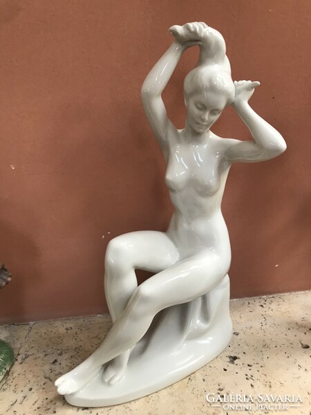 Porcelain lady combing her hair, in good condition