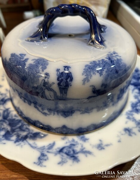 A beautiful earthenware cheese holder with a genre scene