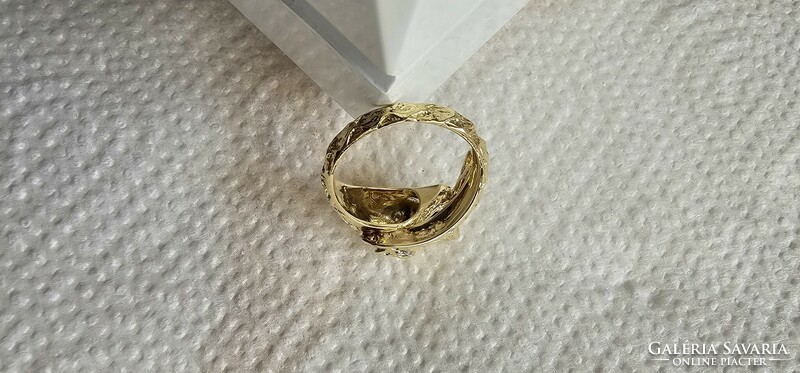 Snake head women's gold ring with diamond eyes.