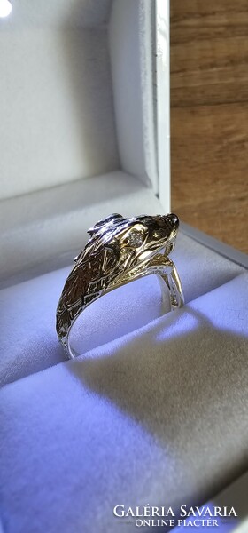 Snake head women's gold ring with diamond eyes.