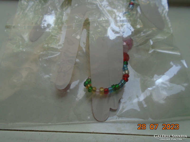 Fashion jewelry hand harness, ring bracelet or new ring bracelet made of colorful pearls, unopened packaging