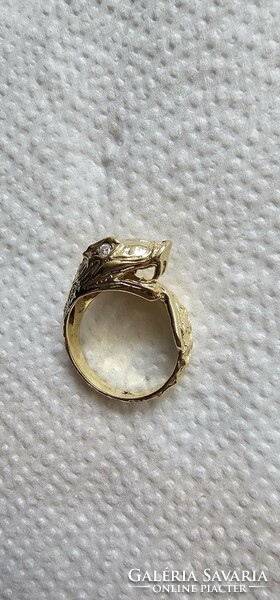 Snake head women's gold ring with diamond eyes.