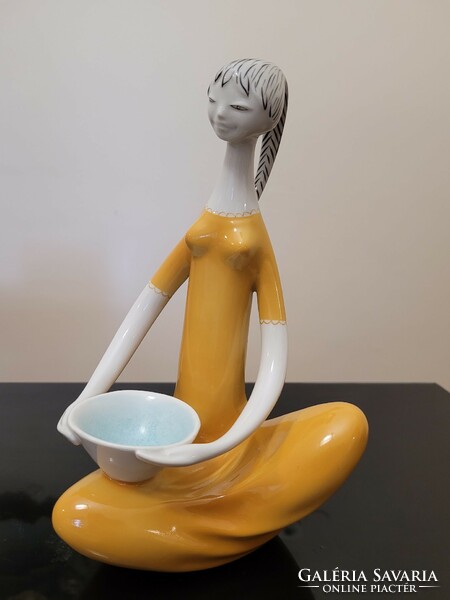 Figure of a girl with an orange bowl from Raven House