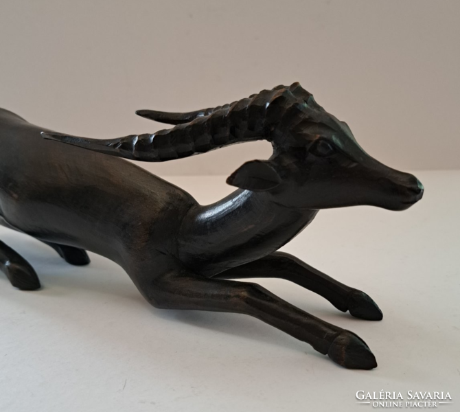 Carved wooden water goat statue