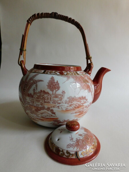 Old Japanese tea pot with bamboo handle