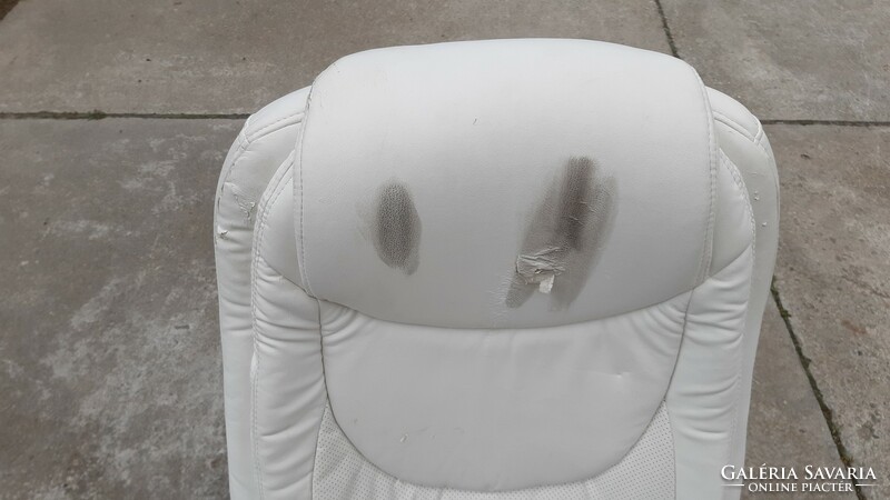 Worn, faulty office castor chair, white faux leather swivel chair