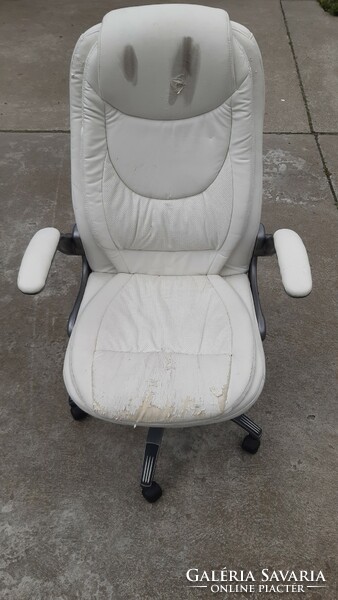 Worn, faulty office castor chair, white faux leather swivel chair
