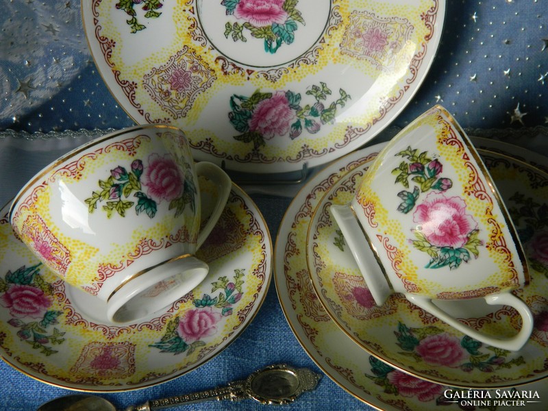 Beautiful floral porcelain breakfast set for 2 people, cups with small plates, pouring