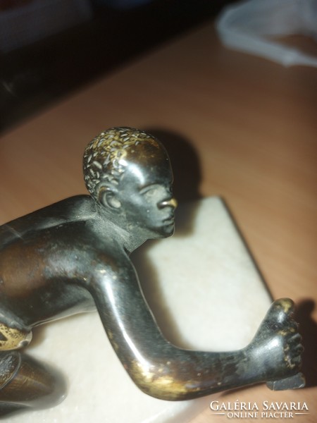 Antique copper statue on a marble base