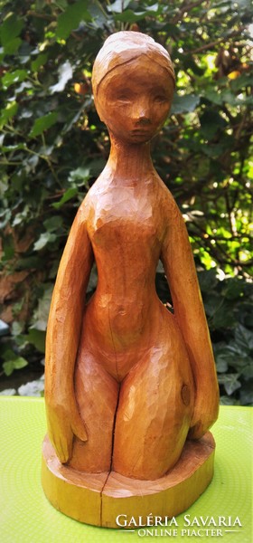 Carved wooden seated female nude