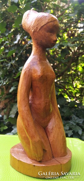 Carved wooden seated female nude