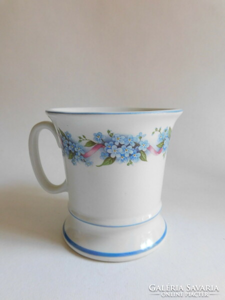 Old mug with forget-me-not pattern